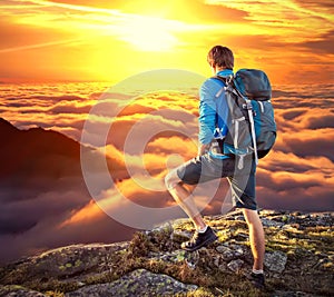 Backpacker on top of mountaine photo