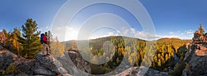 Backpacker on top of a rock fall at dawn. Cylindrical panorama 360 degrees