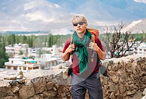 Backpacker tourist arrive in mountain tibetan settelment photo