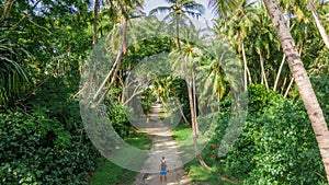 Backpacker travelling alone in the tropical jungles at Manadhoo island capital of Noonu atoll
