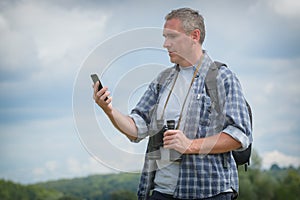 Backpacker using smart phone