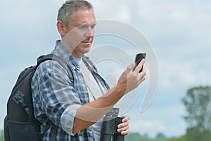 Backpacker using smart phone