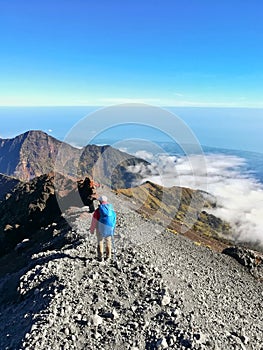 Backpacker walk on the way to Rinjani mountain Summit.