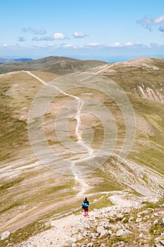 Backpacker walking in the Mountains photo