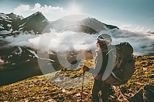 Backpacker woman enjoying mountains clouds