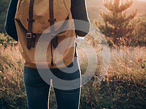 Backpacker woman on journey. Rear view of traveler woman.