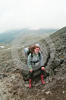 Backpacker a young woman climbing