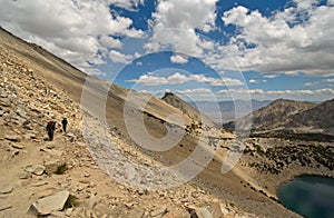 Backpackers approach big mountain pass