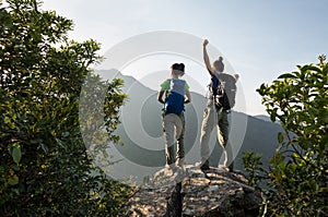 Backpackers enjoy the view on cliff edge