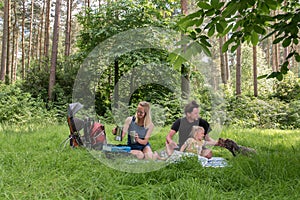 Backpackers family dining in nature