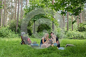 Backpackers family dining in nature