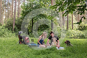 Backpackers family dining in nature