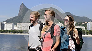 Backpackers tourists in Rio de Janeiro with Christ the Redeemer.