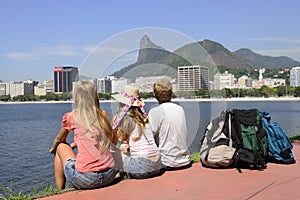 Backpackers tourists in Rio de Janeiro looking at Christ the Redeemer.