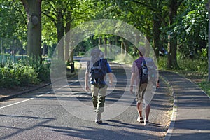 Backpackers walking along avenue