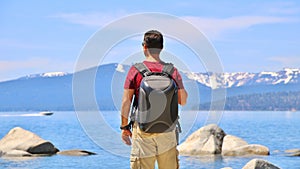 Backpacking by Lake - Speedboat & Snowy Mountains in Background photo