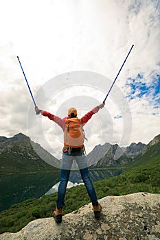 Backpacking woman hiker open arms in mountains