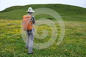 Backpacking woman hiking in mountains