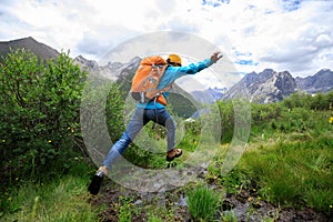 Backpacking woman jumping