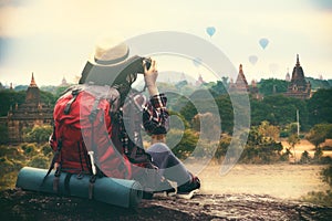 Backpacking woman traveller and photographing in Bagan Mandalay