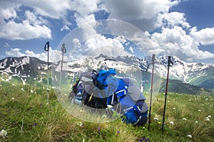 Backpacks and mountain walking sticks in hiking trail. Hiking in mountains concept. Sport tourism.