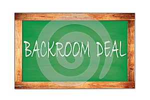 BACKROOM  DEAL text written on green school board