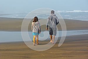 Father Daughter Stroll Beach in Quiet Conversation