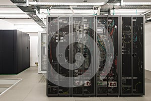Backside of arranged black server racks photo