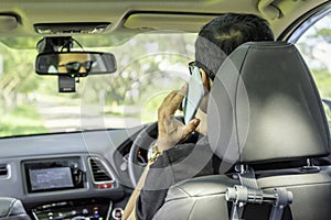 Backside of asian short hair sit in car and use smartphone,car p