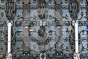 Backside of big LED screen monitor display. Texture of back view panels. Power input and output wire and data input and