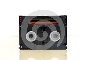 Backside of Mini DV video cassette - tape, isolated on white background. Vintage video recording technology from 1990s.