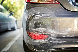 Backside of new silver car get scratched, damaged by accident on parking