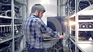 Backside view of an adult man working in a mining rig