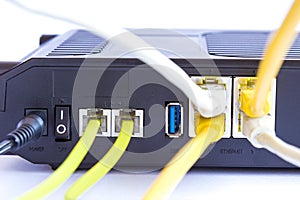 Backside view of dual band wifi router with cat-6 and phone cables connected to the modem. Internet security concept