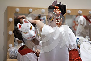 Backstage two actresses prepare for the performance