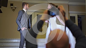 Backstage wedding photography - professional photographers take pictures of newlyweds in a chic room