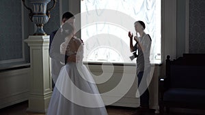 Backstage wedding photography - professional photographers take pictures of newlyweds in a chic room