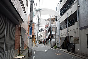 Backstreet lined with buildings and electric cables