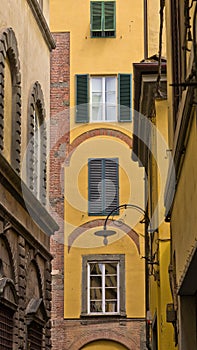 Backstreet with typical italian houses in Lucca, Tuscany photo