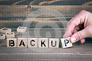 Backup. Wooden letters on the office desk, informative and communication background