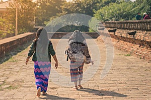 Backview of female tourists at ancient Pa Hto Taw Gyi Pagoda ruins at Mingun city