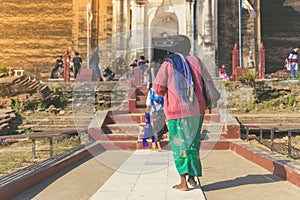 Backview of female tourists at ancient Pa Hto Taw Gyi Pagoda ruins at Mingun city