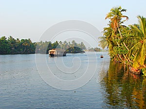 A Backwater Canal with Houseboat and Palm Trees, Kerala, India - A Natural Background