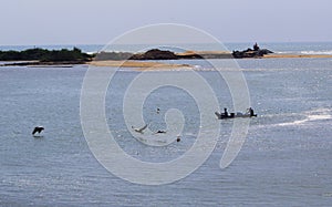 Backwater with fishermen boat and birds