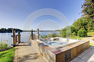 Backyard area with hot tub and awesome water view.