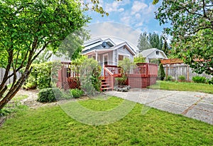 Backyard of craftsman home with red deck