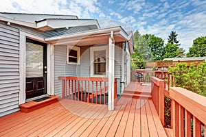 Backyard of craftsman home with red deck