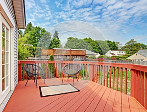 Backyard of craftsman home with red deck