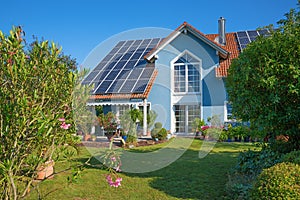 Backyard garden of a beautiful family home with solar panels on the roof