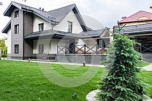 Backyard landscape design with grass and granite paving stoneLarge house with walkway and lots of grass. Beautiful exterior of new